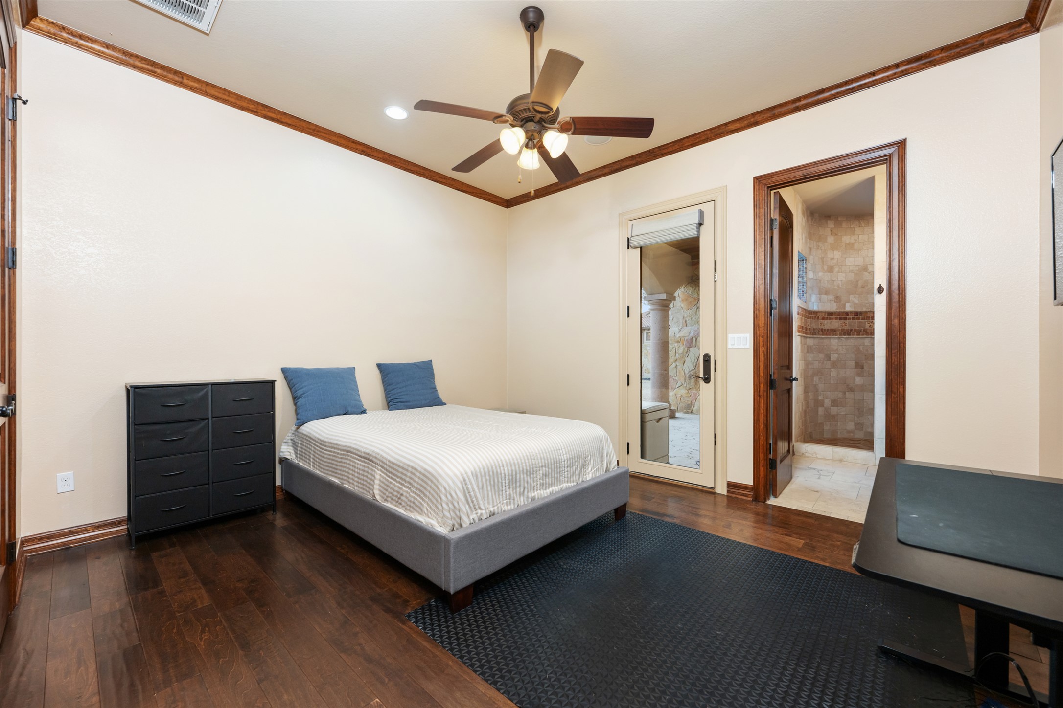 101 Hopewell Circle Georgetown, TX 78628 - Photo 27 of 38 Bedroom featuring ensuite bath, dark wood-style floors, crown molding, and a ceiling fan
