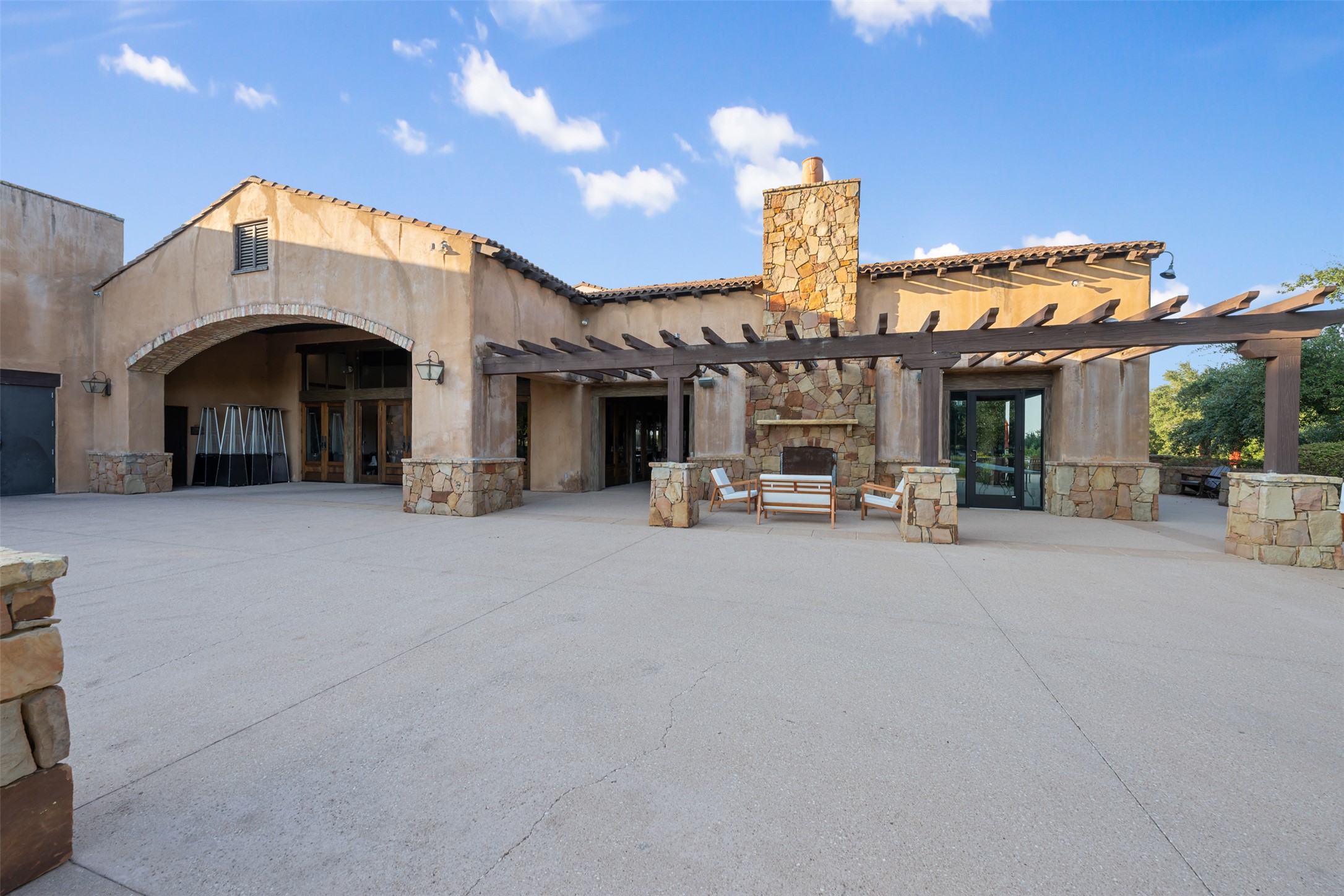 101 Hopewell Circle Georgetown, TX 78628 - Photo 36 of 38 Rear view of house featuring a pergola, stone siding, a chimney, and stucco siding