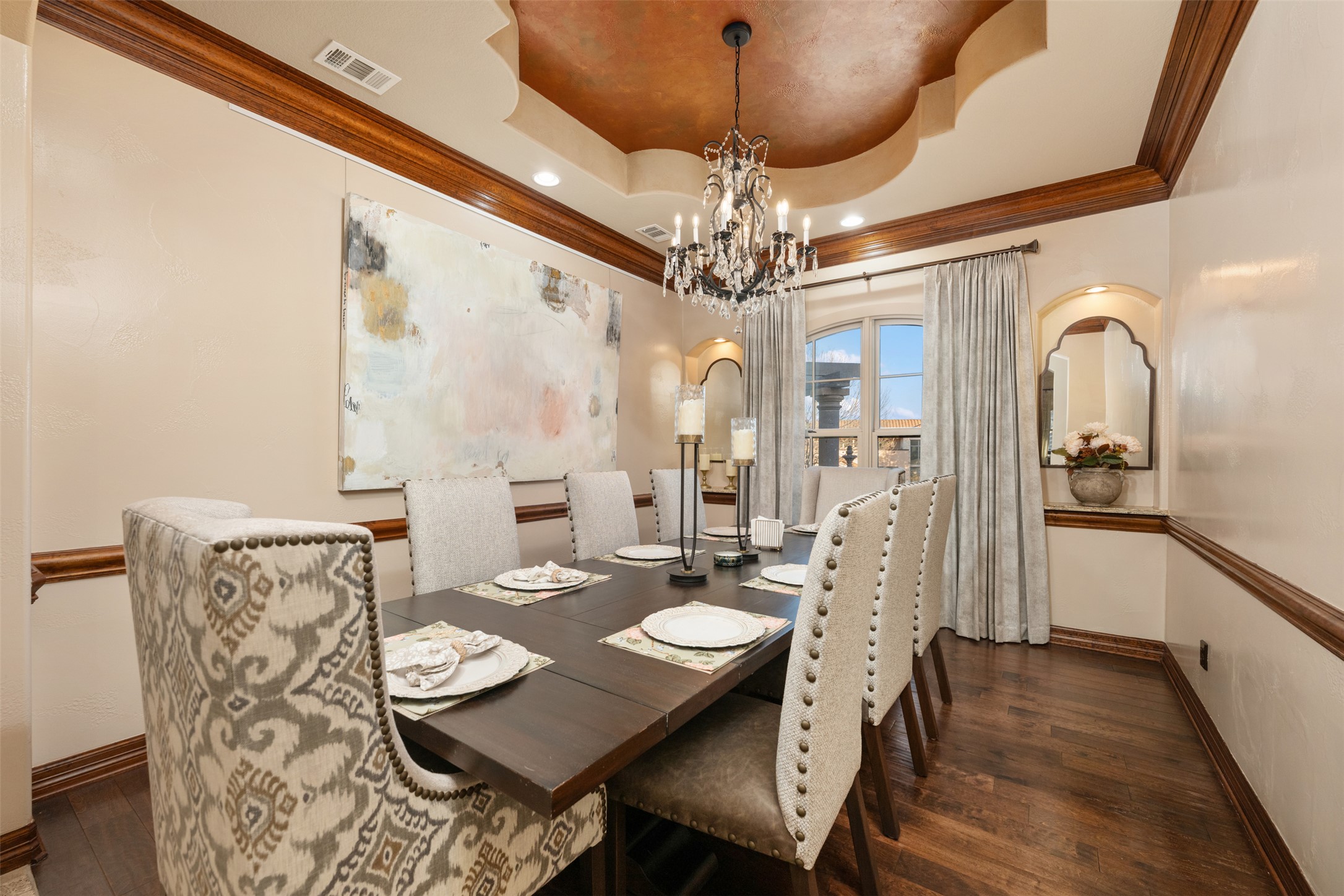 101 Hopewell Circle Georgetown, TX 78628 - Photo 5 of 38 Dining space featuring ornamental molding, dark wood-type flooring, a chandelier, a raised ceiling, and arched walkways