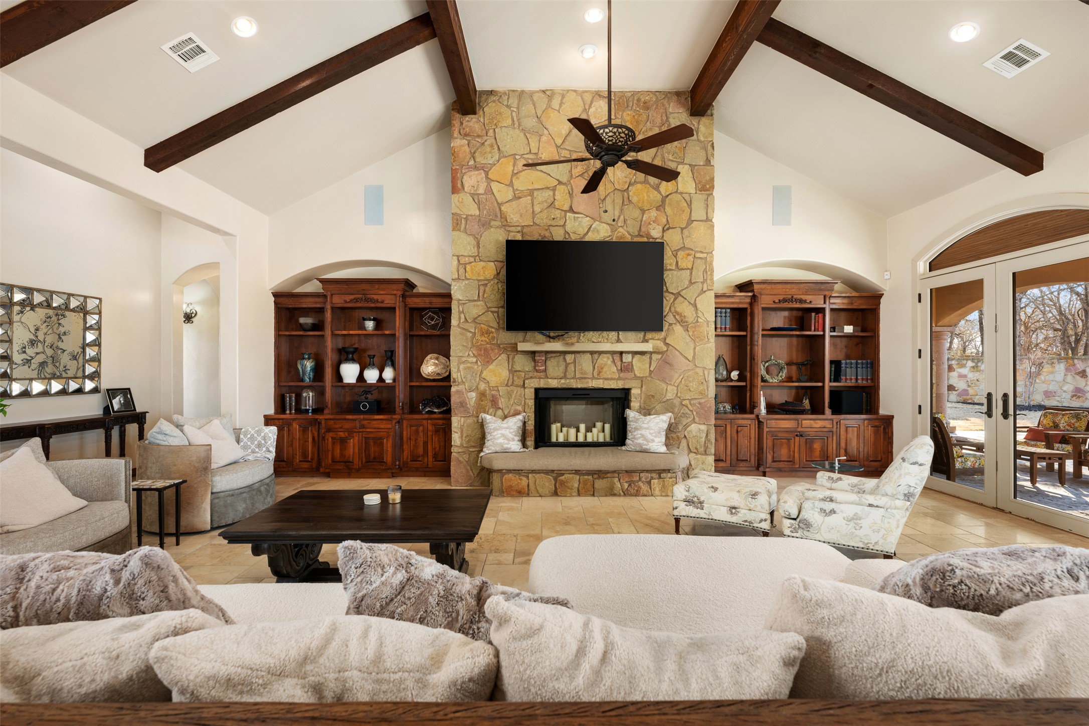 101 Hopewell Circle Georgetown, TX 78628 - Photo 7 of 38 Living room featuring a high ceiling, a fireplace, french doors, arched walkways, and a ceiling fan
