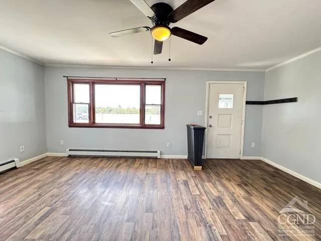 wooden floor in an empty room with a window