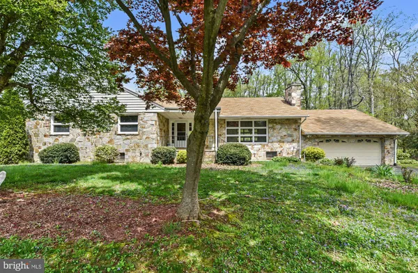 a view of a house with yard and sitting area