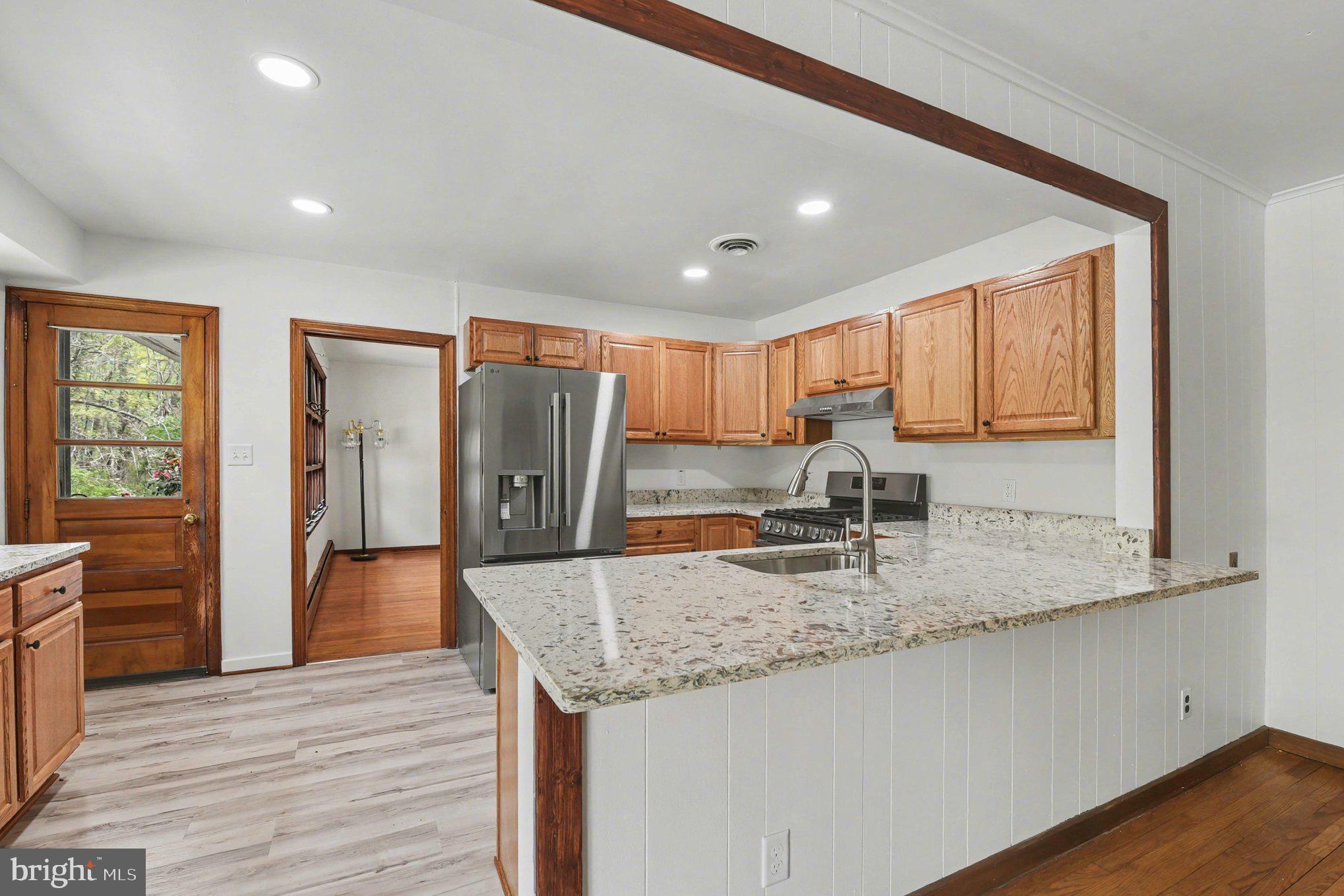 3418 Walnut Road Aberdeen, MD 21001 - Photo 4 of 38 a kitchen with stainless steel appliances granite countertop wooden floors and granite counter tops