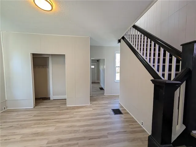 a view of an entryway with wooden floor
