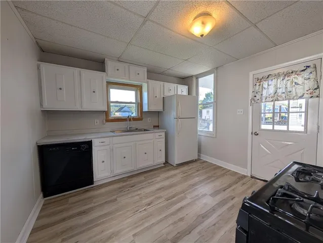 a kitchen with a stove window and cabinets