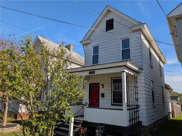 a view of a house with a tree