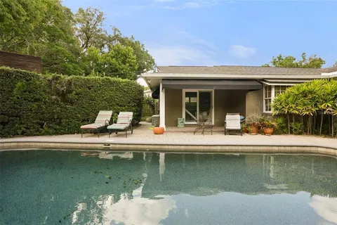 a view of a house with swimming pool next to a lake view