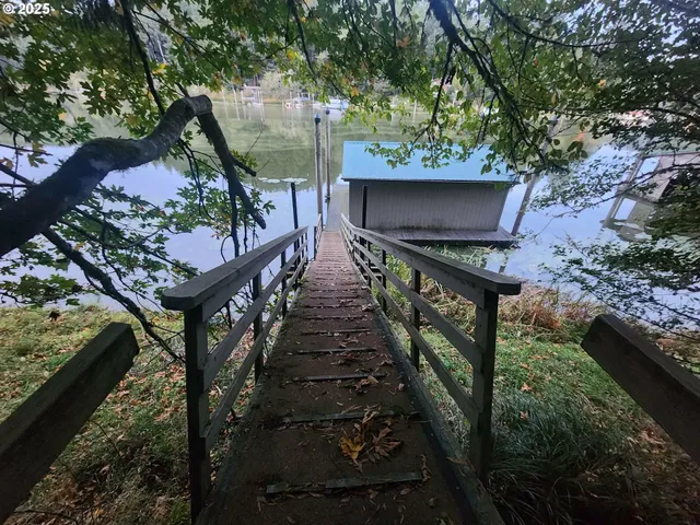 a balcony with wooden floor and outdoor seating