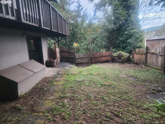a view of a house with a yard and sitting area