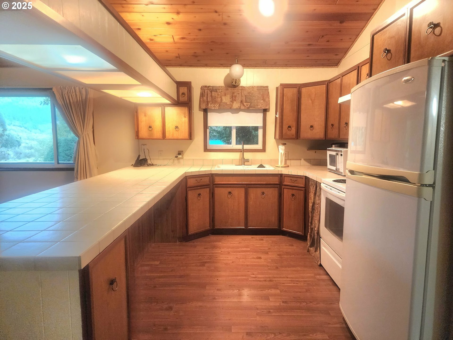 763 North Tenmile Lakeside, OR 97449 - Photo 20 of 47 a kitchen with stainless steel appliances granite countertop a sink a stove and refrigerator