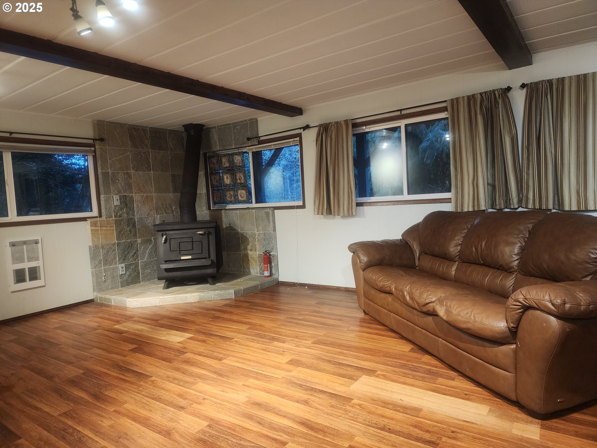 763 North Tenmile Lakeside, OR 97449 - Photo 25 of 47 a living room with furniture and a flat screen tv