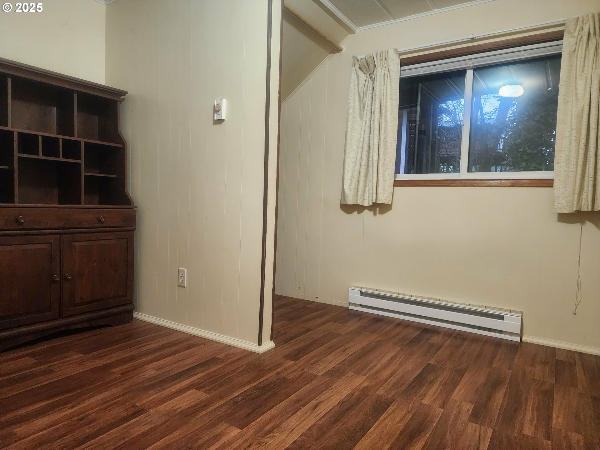 763 North Tenmile Lakeside, OR 97449 - Photo 34 of 47 a view of empty room with wooden floor and fan