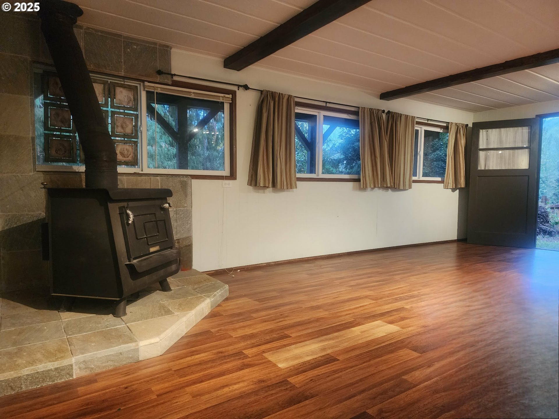 763 North Tenmile Lakeside, OR 97449 - Photo 39 of 47 a view of an empty room with wooden floor and windows