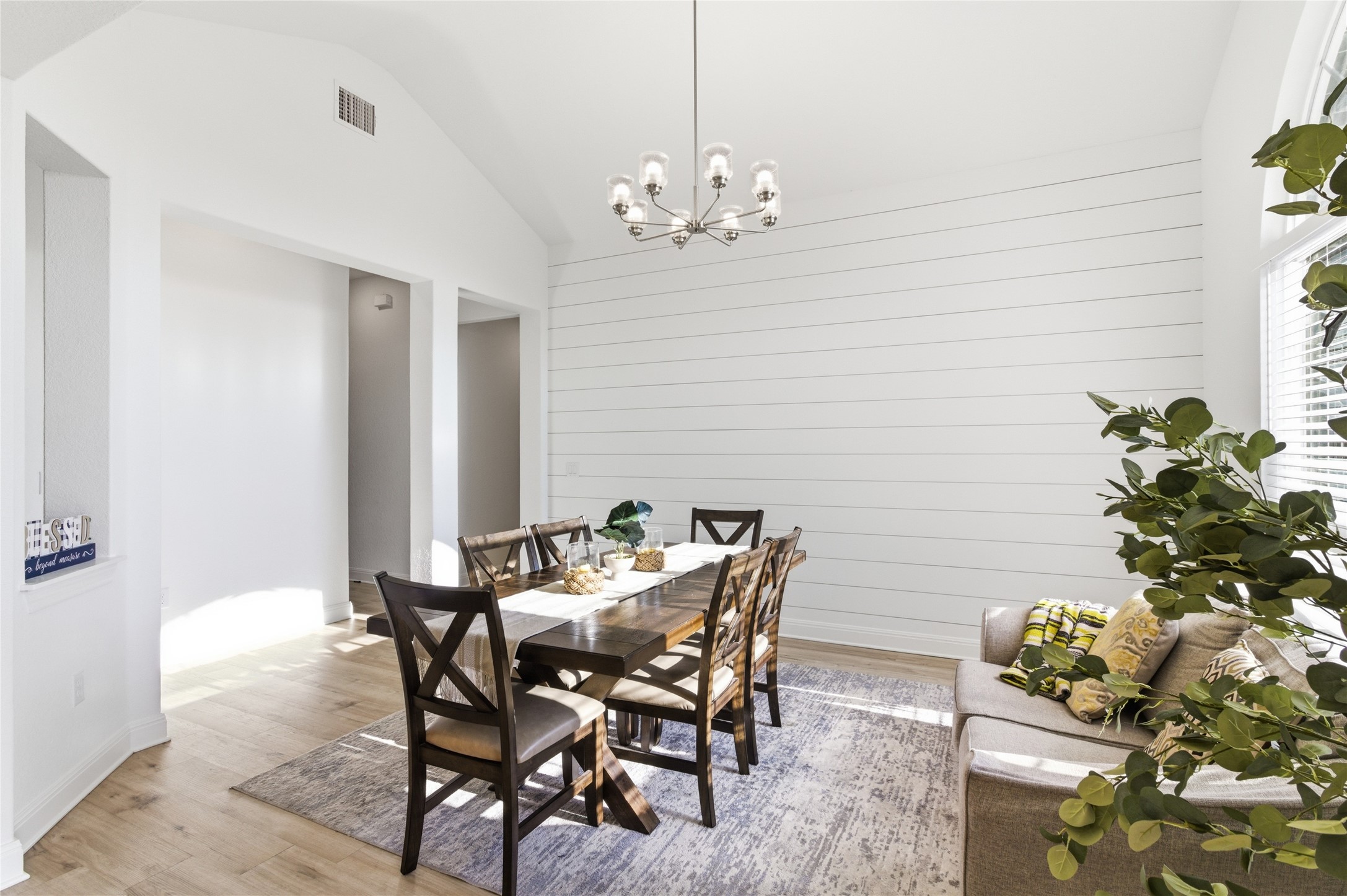 2032 Rushing Ranch Path Georgetown, TX 78628 - Photo 13 of 30 Vaulted ceilings and a shiplap accent wall create a welcoming dining space.