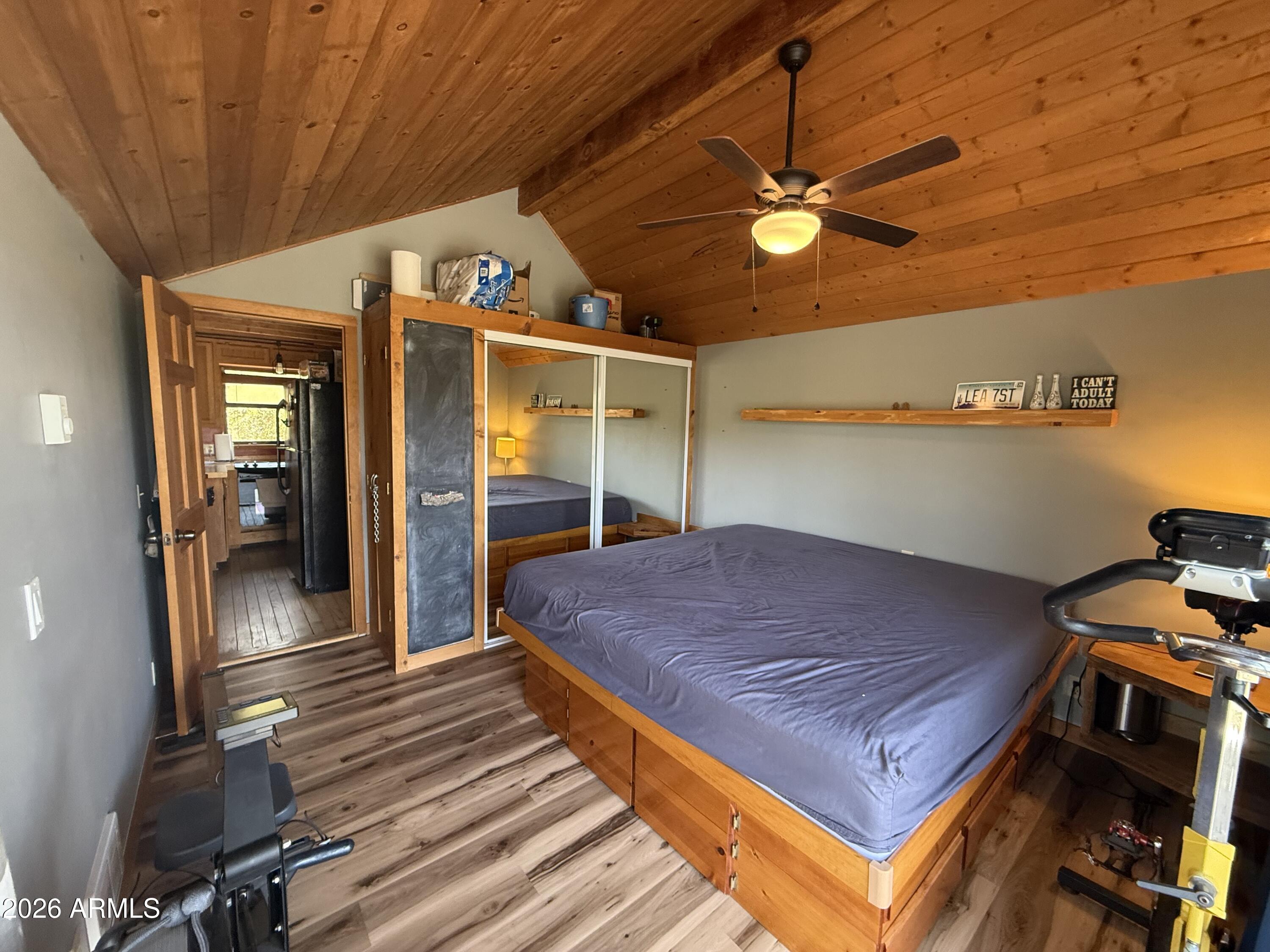 6687 Mountain View Road Crown King, AZ 86343 - Photo 7 of 18 a bedroom with a bed and a chandelier