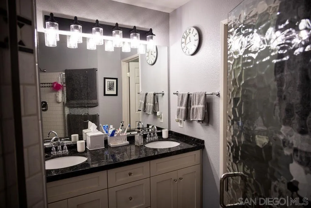 13890 Pinkard Way, Unit 68 El Cajon, CA 92021 - Photo 15 of 25 a bathroom with a sink and a mirror