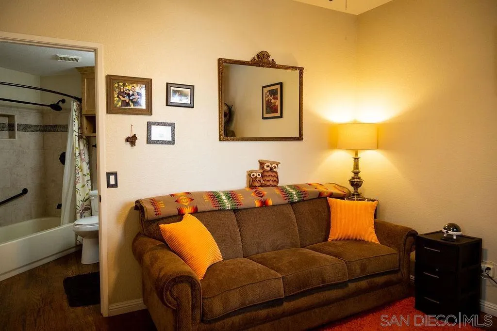 13890 Pinkard Way, Unit 68 El Cajon, CA 92021 - Photo 18 of 25 a blue couch sitting in a living room with a couch