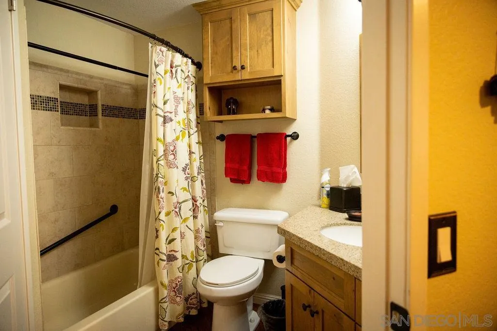 13890 Pinkard Way, Unit 68 El Cajon, CA 92021 - Photo 21 of 25 a bathroom with a sink toilet and shower