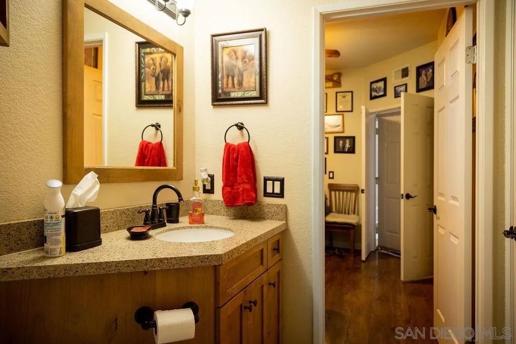 13890 Pinkard Way, Unit 68 El Cajon, CA 92021 - Photo 22 of 25 a bathroom with a sink and a mirror