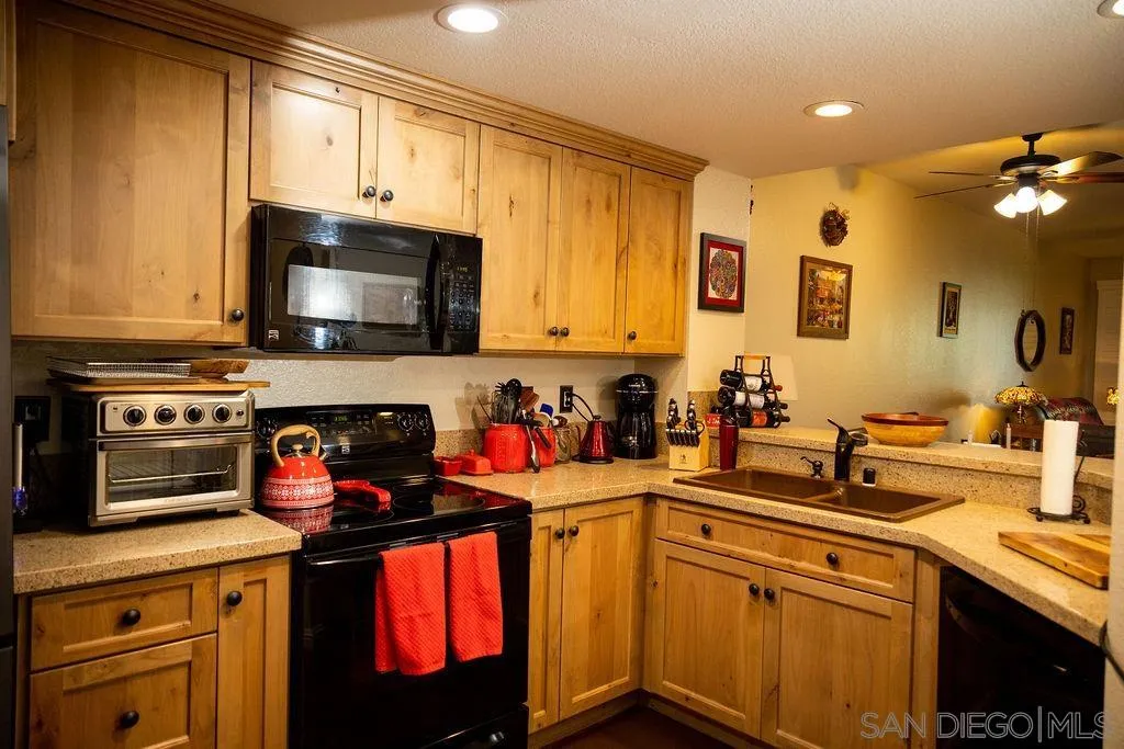 13890 Pinkard Way, Unit 68 El Cajon, CA 92021 - Photo 7 of 25 a kitchen with stainless steel appliances a sink stove and cabinets