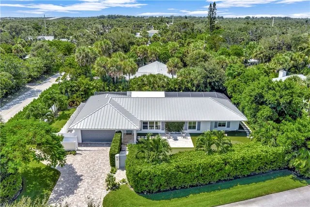 a aerial view of a house with yard and outdoor seating