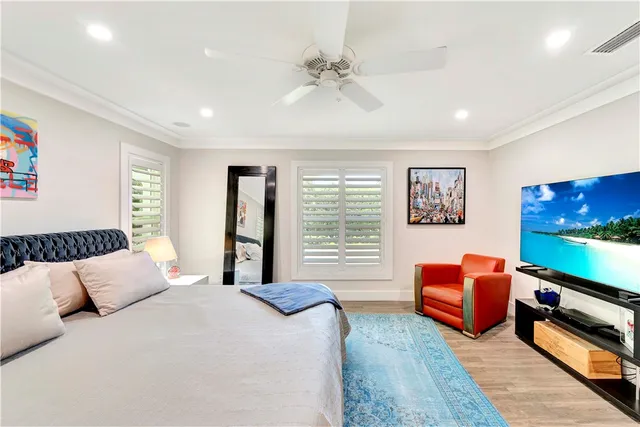 a bedroom with furniture and a flat screen tv