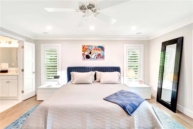 a bedroom with a large bed and a large window