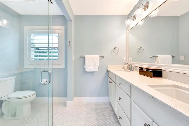 a spacious bathroom with a sink a toilet and shower