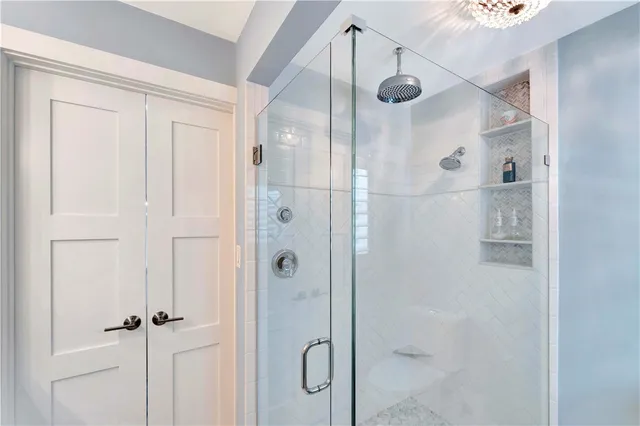a bathroom with a glass shower door