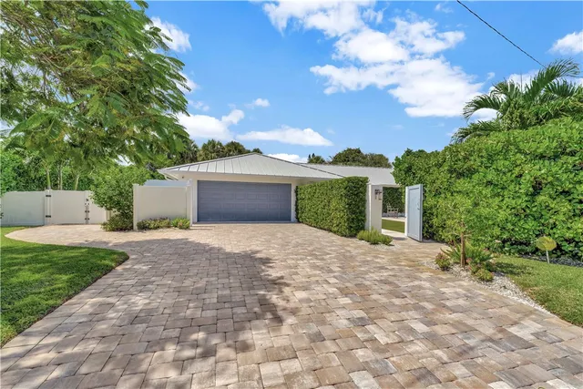 a front view of a house with a yard and a garage