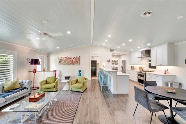 a living room with lots of furniture and kitchen view