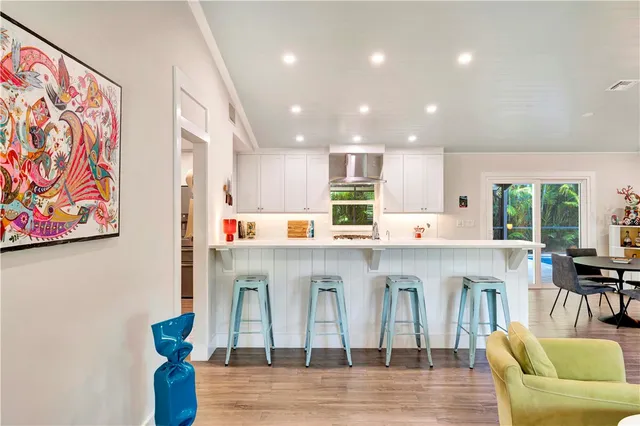 a kitchen with stainless steel appliances granite countertop a refrigerator and a stove top oven