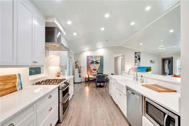 a large white kitchen with a large window