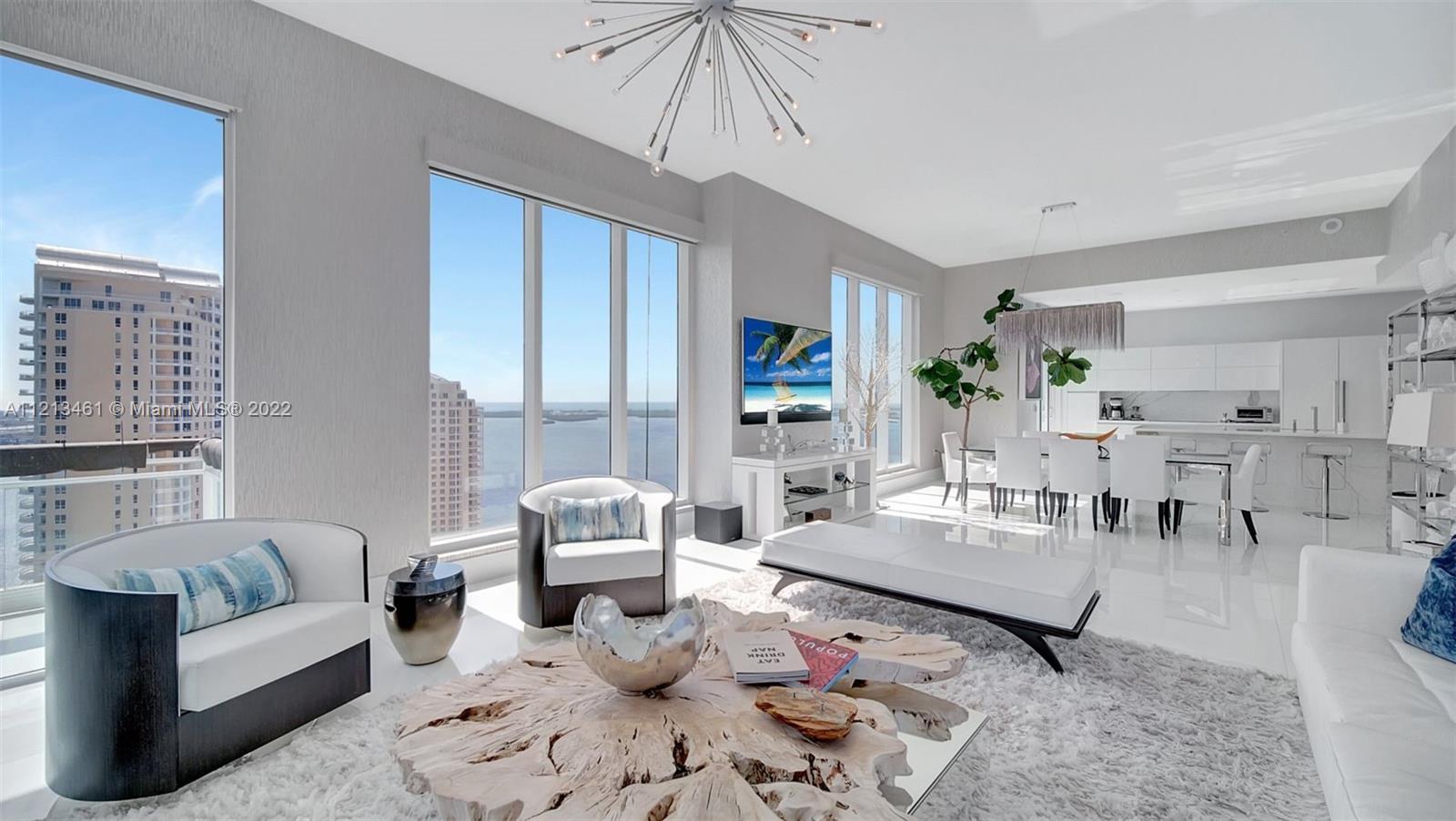 a living room with furniture a rug and a chandelier