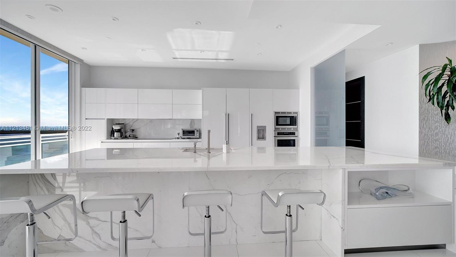 900 Brickell Key Boulevard, Unit 3103 Miami, FL 33131 - Photo 13 of 46 a kitchen with stainless steel appliances granite countertop a sink and cabinets