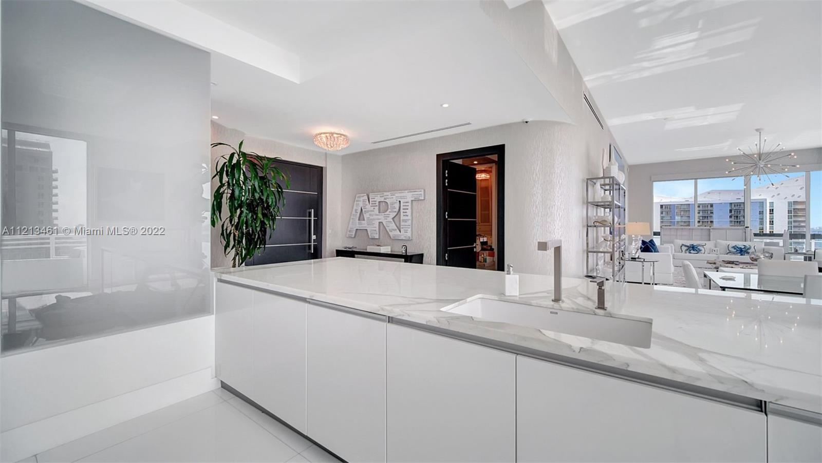 900 Brickell Key Boulevard, Unit 3103 Miami, FL 33131 - Photo 14 of 46 a bathroom with a tub sink and mirror