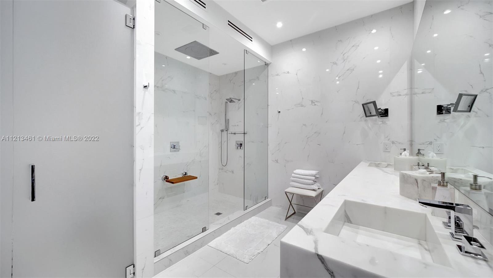 900 Brickell Key Boulevard, Unit 3103 Miami, FL 33131 - Photo 19 of 46 a bathroom with a tub and a sink