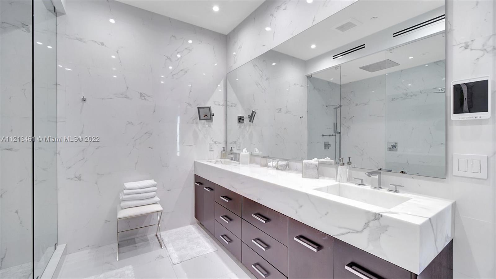 900 Brickell Key Boulevard, Unit 3103 Miami, FL 33131 - Photo 20 of 46 a bathroom with a double vanity sink mirror and toilet