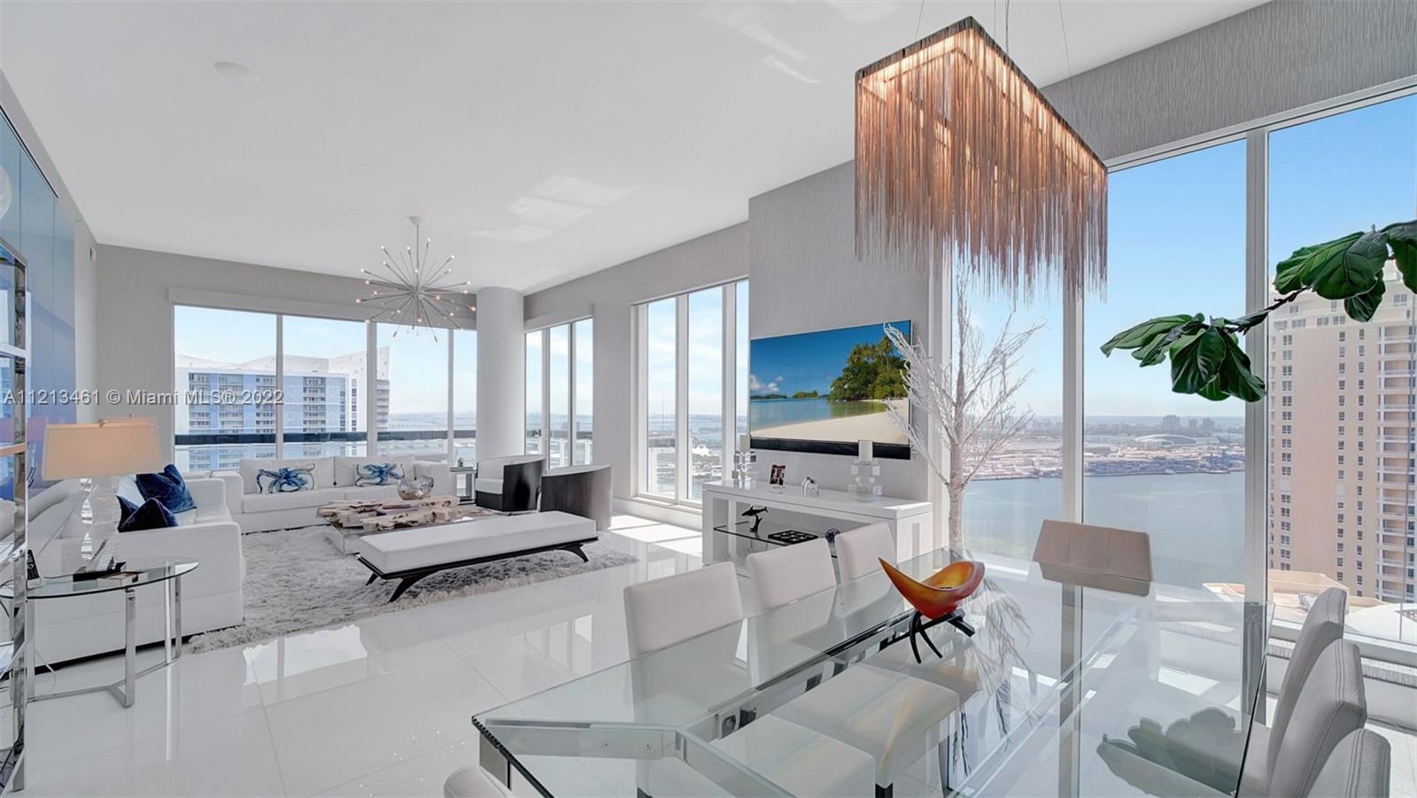 900 Brickell Key Boulevard, Unit 3103 Miami, FL 33131 - Photo 2 of 46 a living room with furniture fireplace and a potted plant