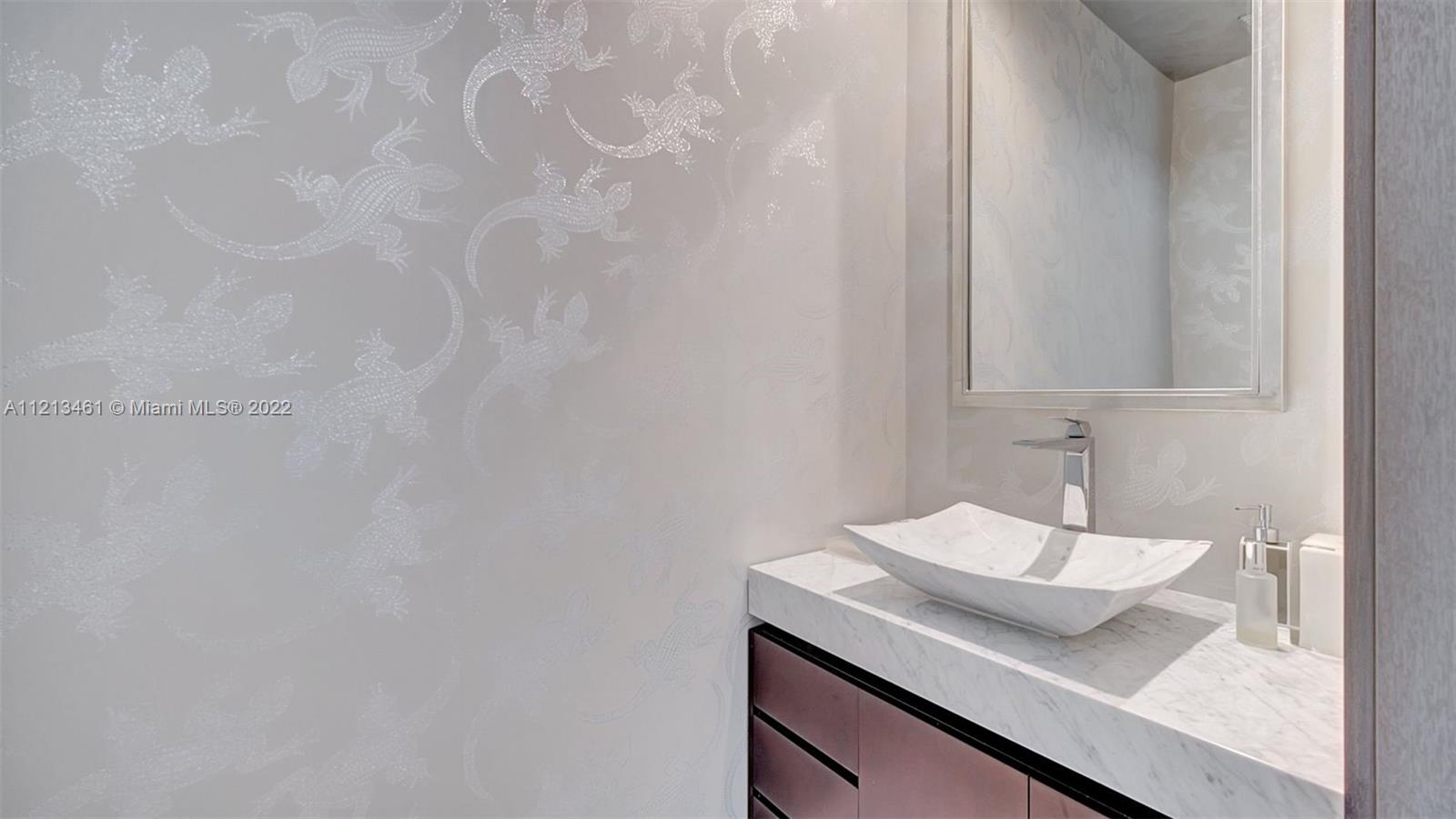 900 Brickell Key Boulevard, Unit 3103 Miami, FL 33131 - Photo 26 of 46 a bathroom with a sink and a mirror