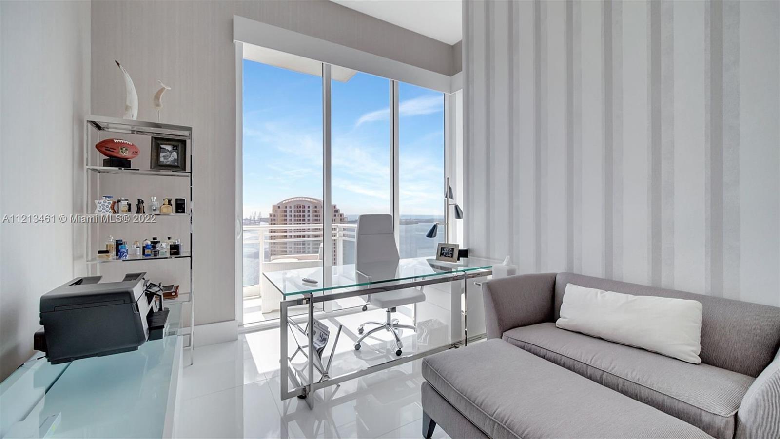 900 Brickell Key Boulevard, Unit 3103 Miami, FL 33131 - Photo 28 of 46 a living room with furniture a flat screen tv and a window