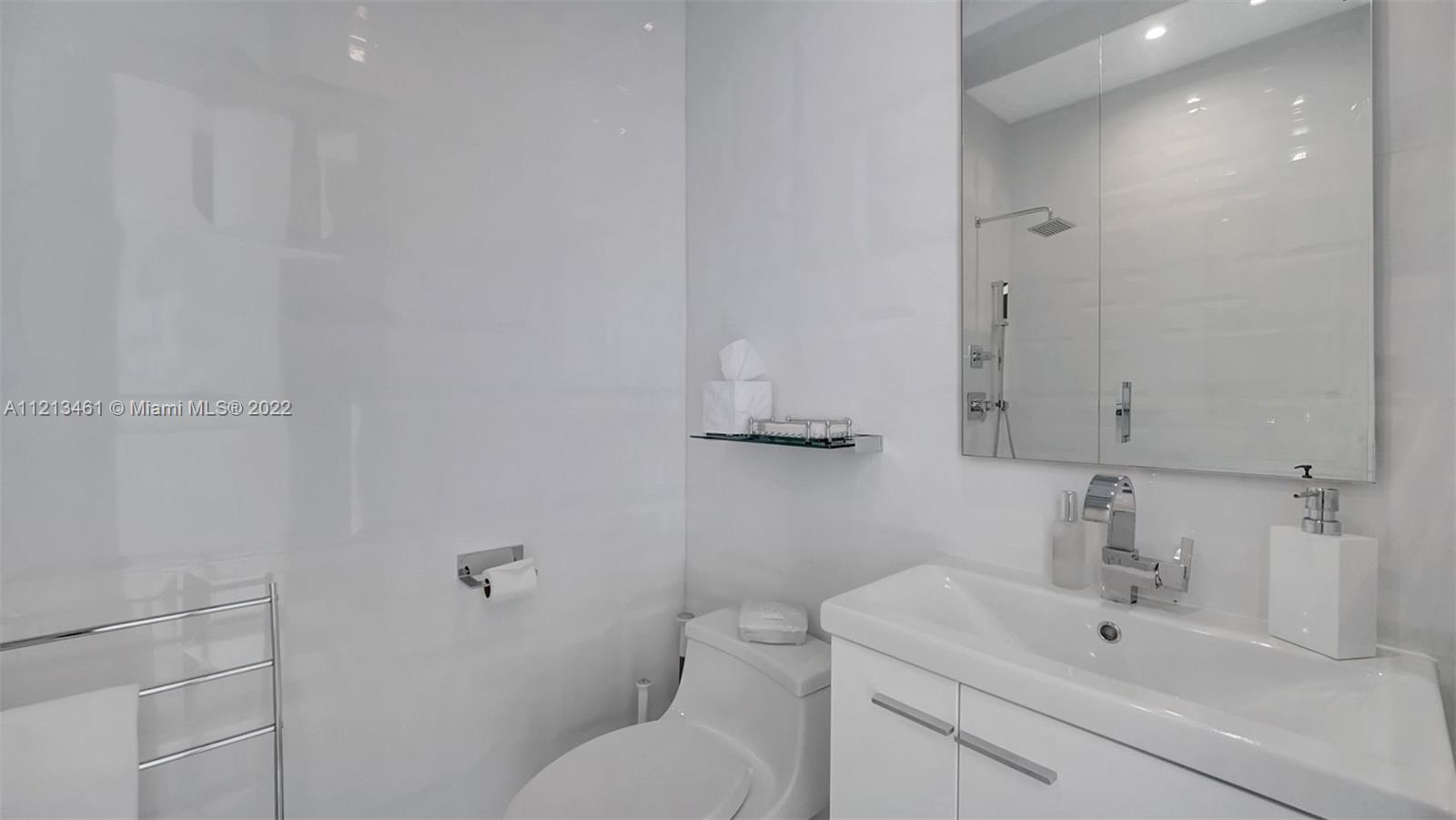 900 Brickell Key Boulevard, Unit 3103 Miami, FL 33131 - Photo 30 of 46 a bathroom with a sink toilet and vanity