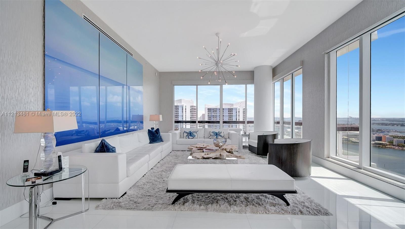 900 Brickell Key Boulevard, Unit 3103 Miami, FL 33131 - Photo 3 of 46 a living room with furniture and a large window