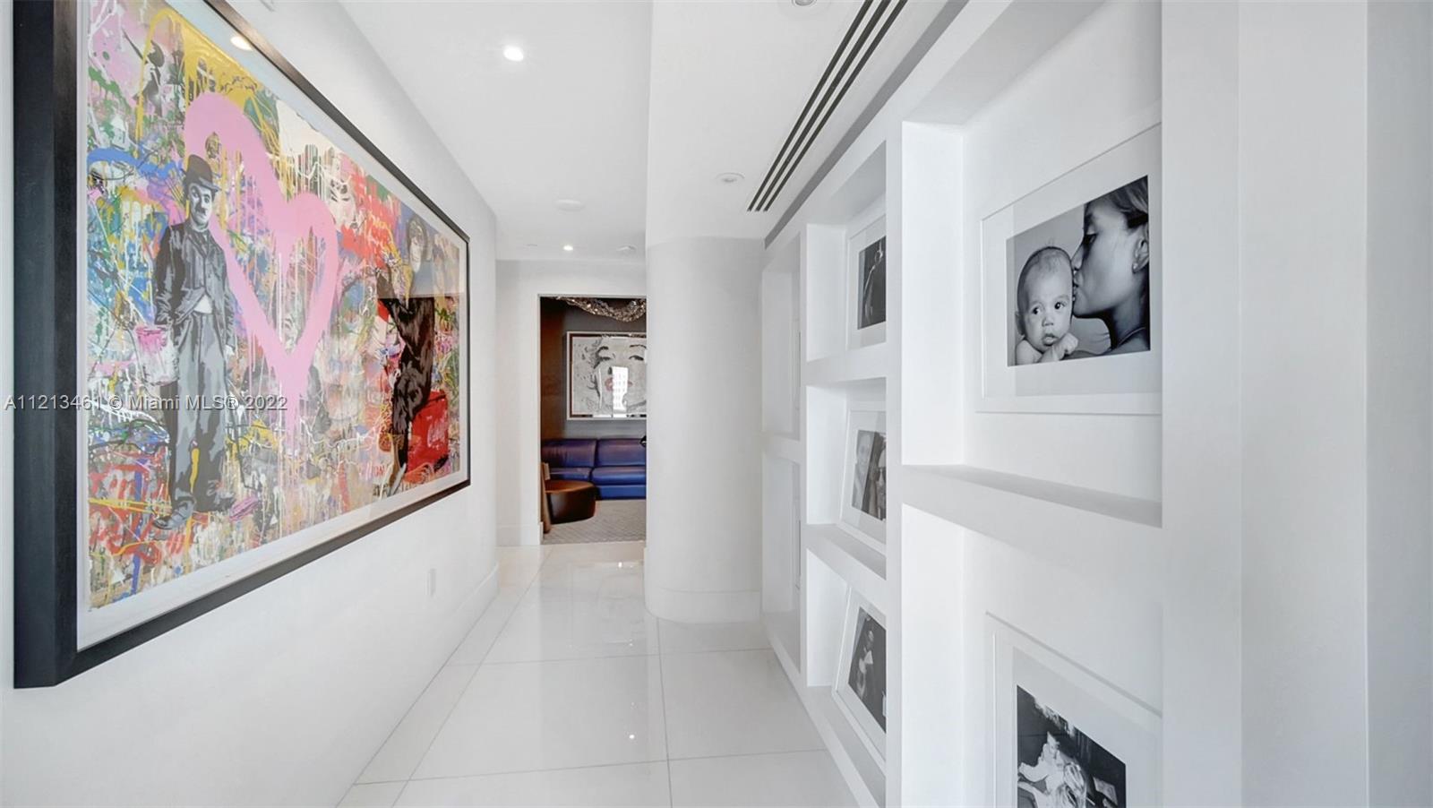 900 Brickell Key Boulevard, Unit 3103 Miami, FL 33131 - Photo 31 of 46 a hallway with painting on the wall and a painting on the wall