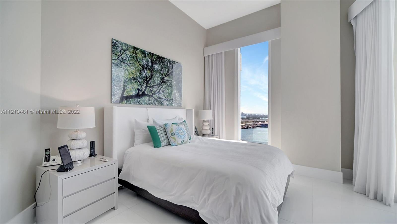 900 Brickell Key Boulevard, Unit 3103 Miami, FL 33131 - Photo 35 of 46 a bedroom with a bed and a painting on the wall