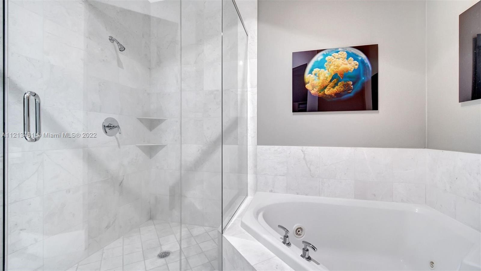 900 Brickell Key Boulevard, Unit 3103 Miami, FL 33131 - Photo 37 of 46 a bathroom with a bathtub and a shower