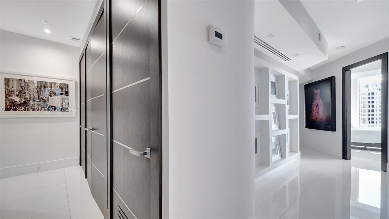 900 Brickell Key Boulevard, Unit 3103 Miami, FL 33131 - Photo 40 of 46 a view of a hallway with wooden floor