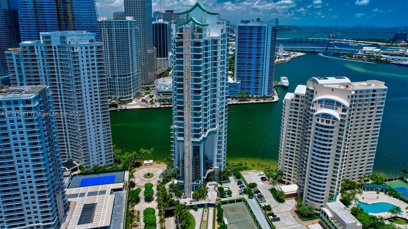 900 Brickell Key Boulevard, Unit 3103 Miami, FL 33131 - Photo 43 of 46 a green building with a yard