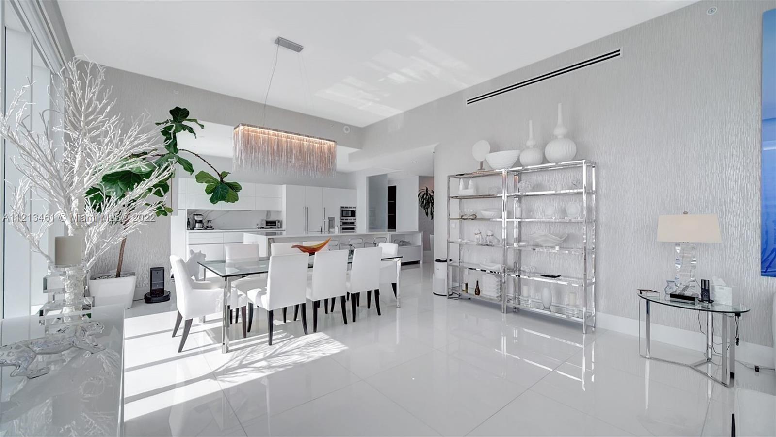 900 Brickell Key Boulevard, Unit 3103 Miami, FL 33131 - Photo 6 of 46 a living room with furniture a dining table and a painting on the wall