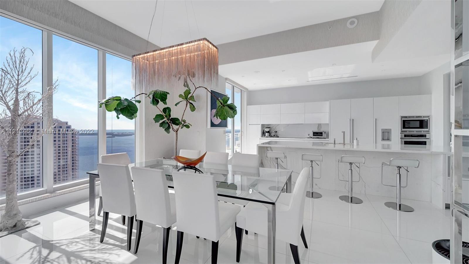 900 Brickell Key Boulevard, Unit 3103 Miami, FL 33131 - Photo 8 of 46 a dining room with furniture and a potted plant